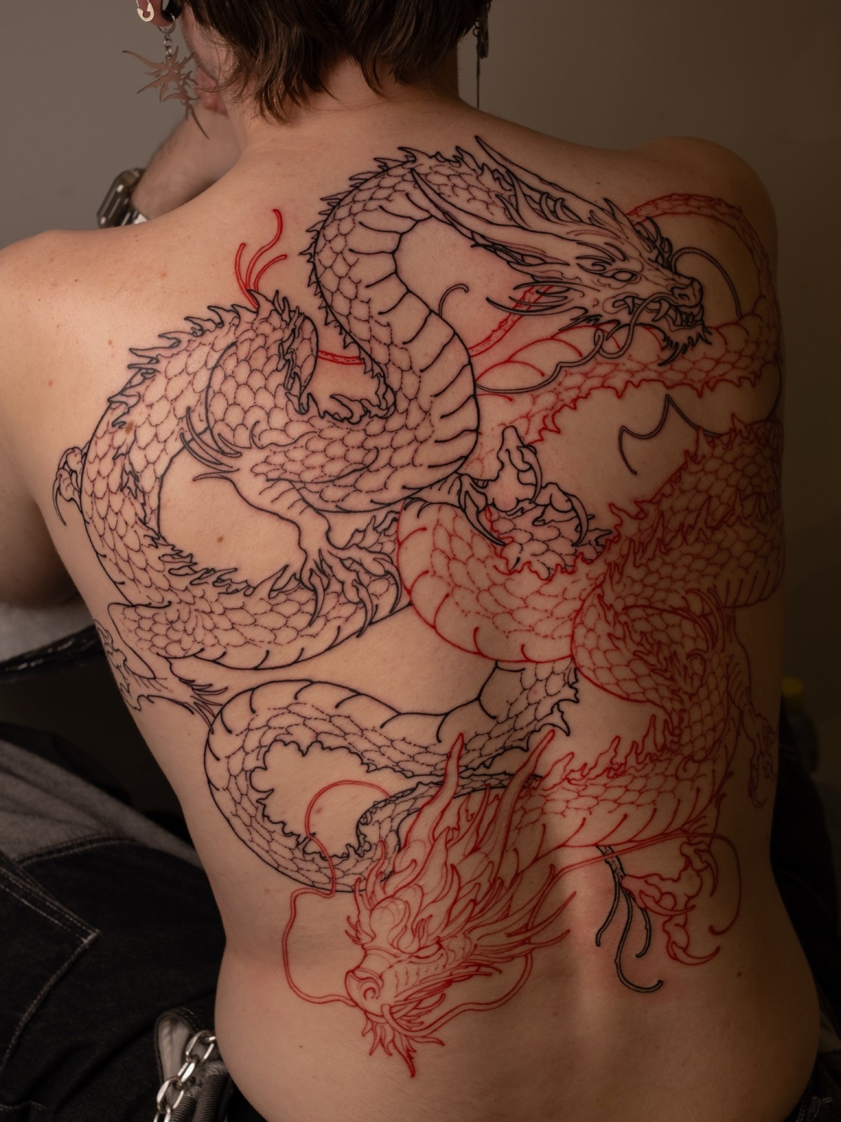 Twin dragons — full back piece in black and red linework